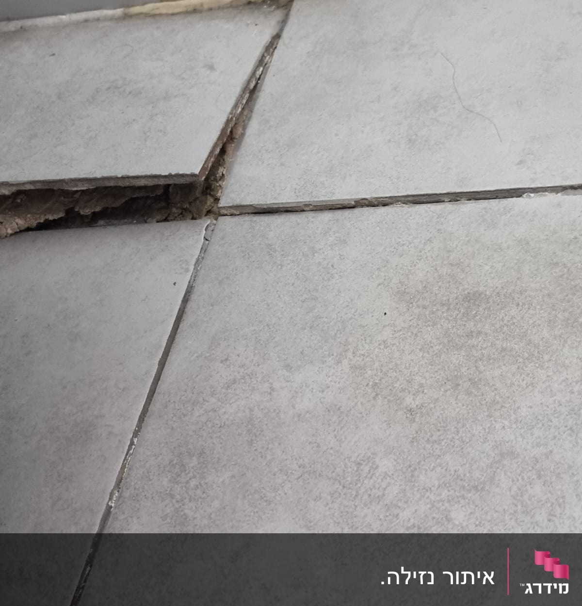 אריח רצפה שבור עם חשיפת תשתית מתחת